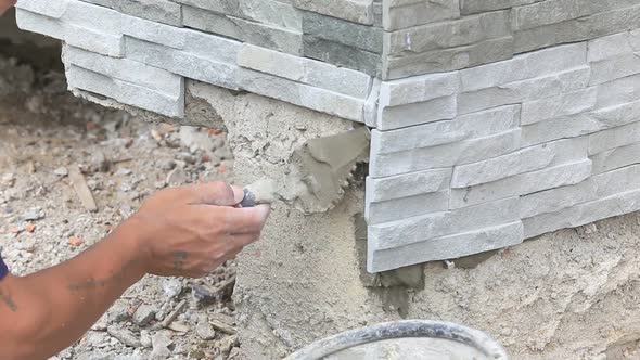 Worker Install Stone Wall Surface With Cement For House 9