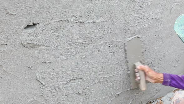 Worker Plastering Concrete At Wall Of House Construction 2