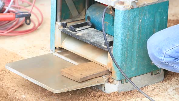 Carpenter Putting Board Through A Planer 1 alt