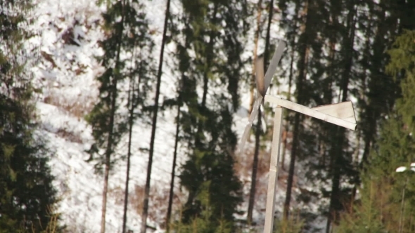 Wooden Windmill Spinning In The Wind In Winter.