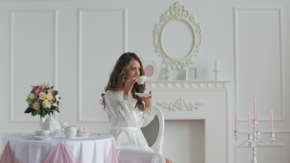 Beautiful Woman In Bathrobe Drinking Coffee