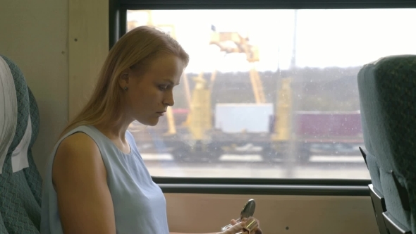 Woman Applying Make-up In Train