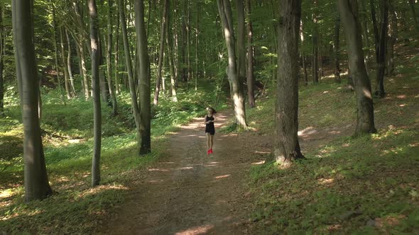 Woman Running at Forest