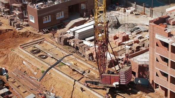 Crane Unloads Metal From Truck Construction Site