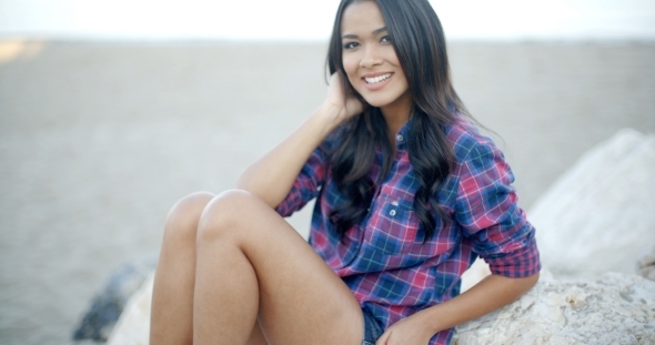 Woman Resting On Stone Coast alt