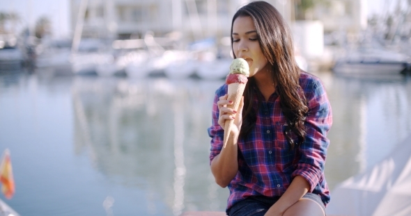 Woman Enjoying Ice Cream On Vacation alt