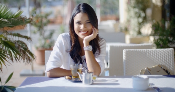 Girl Sitting At Cafe With Cup Of Tea