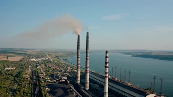 Aerial Drone View of High Chimney Pipes with Grey Smoke From Coal Power Plant. Close Up