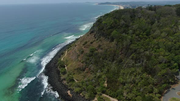 Flying backwards Burleigh Heads National Park,  waves breaking bright sunny day, walking track below