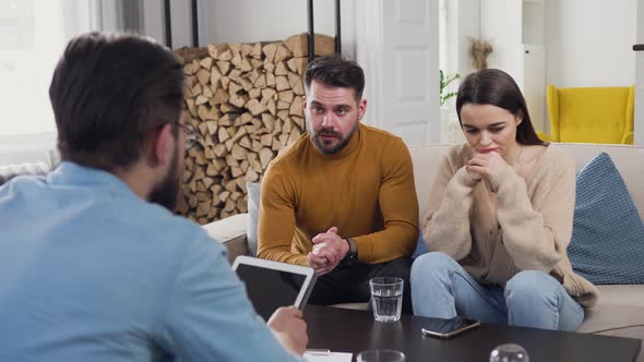 Married Couple Sitting on the Sofa in the Psychologist Visit