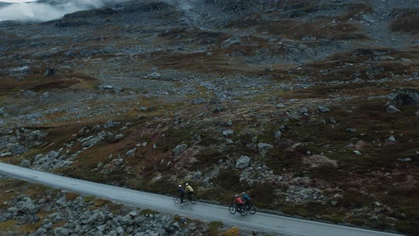 Flying Drone View of Cyclists Team in Mountains