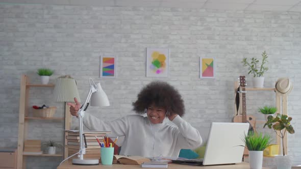 African American Woman with an Afro Hairstyle Listening To Music with Headphones and Dancing Slow Mo