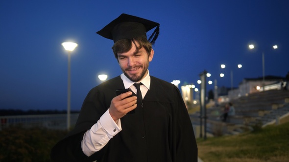 Graduate student walking in the evening and texting message