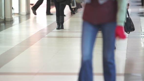 Legs Of People Walking Around The Store