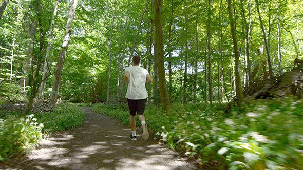 Young Man Running On Trail 