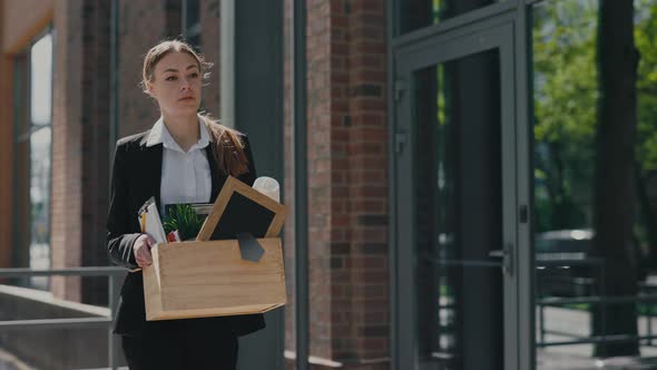 Woman Feeling Worried About Job Loss While Walking on Street