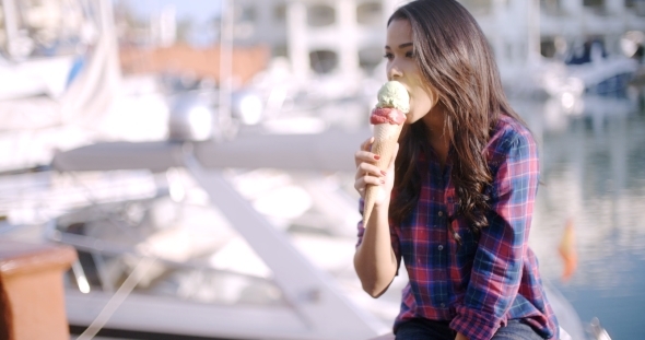 Woman Enjoying Ice Cream On Vacation alt