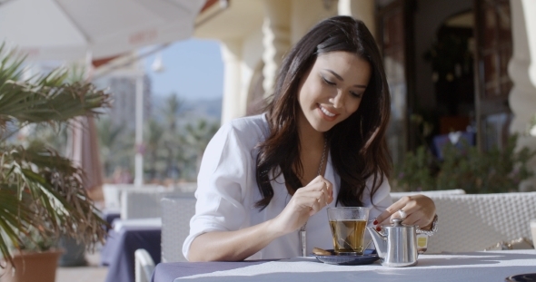 Girl Sitting At Cafe With Cup Of Tea