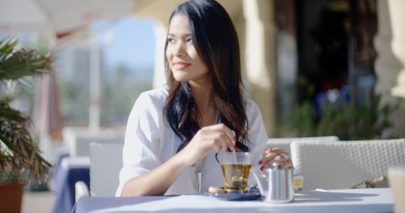 Girl Sitting At Cafe With Cup Of Tea