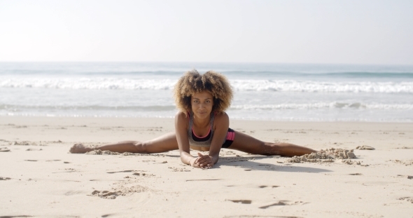 Woman In Yoga Position At The Beach