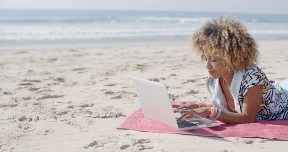 Woman At The Beach Working On A Laptop