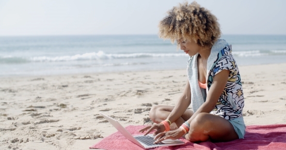 Girl Working With Laptop On The Sand Beach