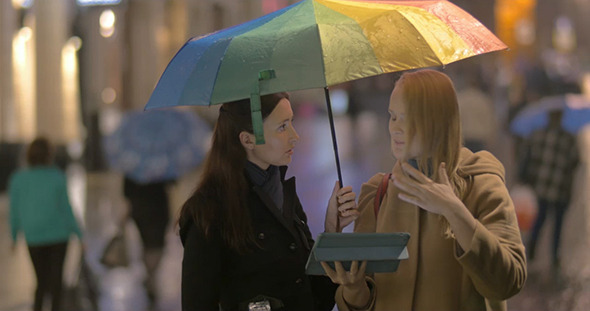 Women Talking On The Street On Rainy Day alt