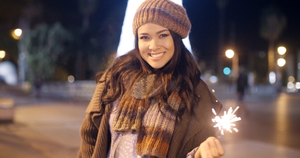 Pretty Young Woman Celebrating With a Sparkler