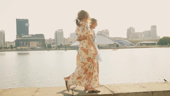 Three young beautiful smiling hipster female in trendy summer sundress posing outdoors