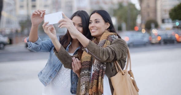 Two Gorgeous Women Posing For a Selfie alt