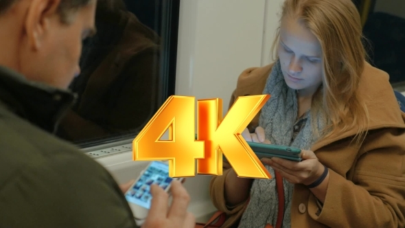 Woman In Metro Train Typing In Tablet