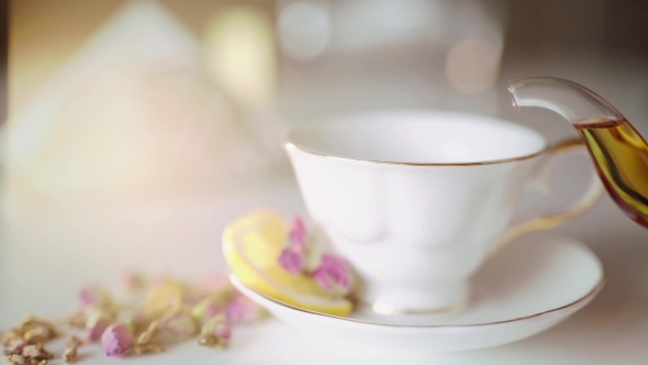 Pour Tea In a Beautiful White Cup With Lemon alt