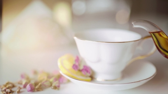 Pour Tea In a Beautiful White Cup With Lemon