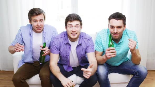 Upset Male Friends With Beer Watching Tv At Home 1