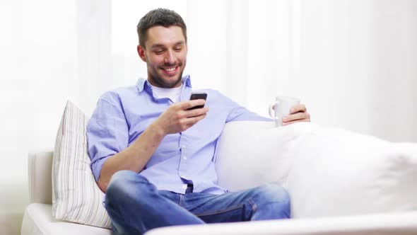 Smiling Man With Smartphone At Home 1