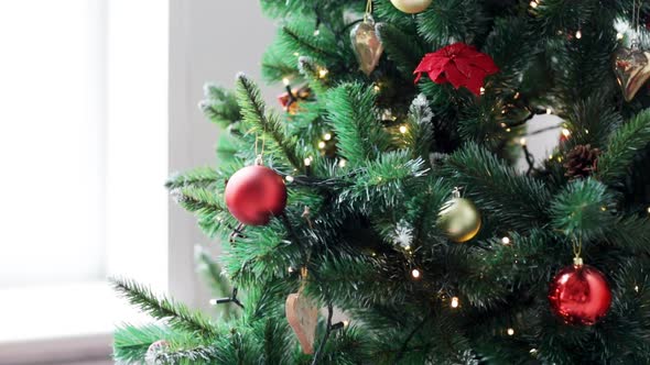 Woman Decorating Christmas Tree With Ball 2