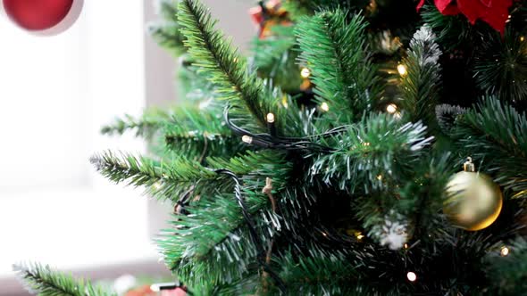 Woman Decorating Christmas Tree With Ball 3 alt