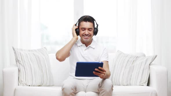 Smiling Man With Tablet Pc And Headphones At Home 3