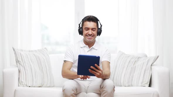 Smiling Man With Tablet Pc And Headphones At Home 4