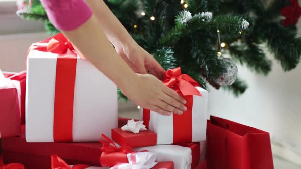 Woman Putting Present Under Christmas Tree 1 alt