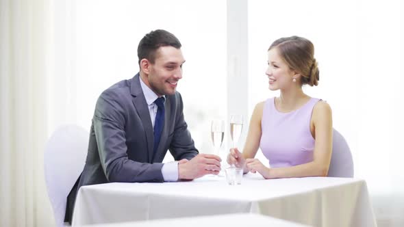 Couple With Glasses Of Champagne At Restaurant