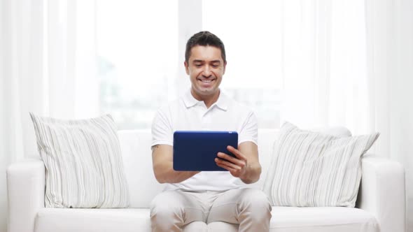 Smiling Man Working With Tablet Pc At Home 1