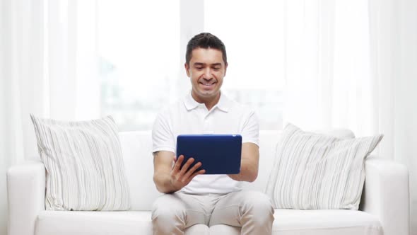Smiling Man Working With Tablet Pc At Home 2