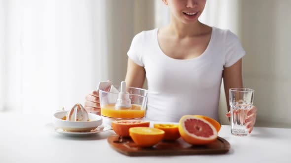 Woman With Squeezer Pouring Orange Juice To Glass 2 alt