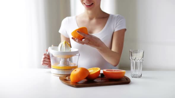 Woman With Squeezer Squeezing Orange Juice At Home 2 alt