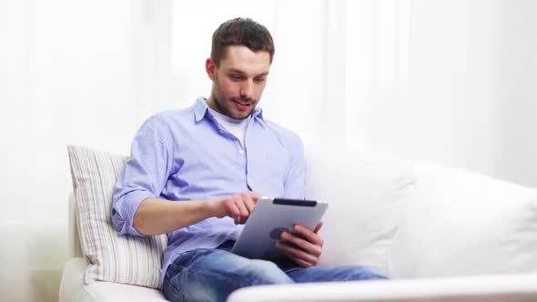 Smiling Man Working With Tablet Pc At Home 7