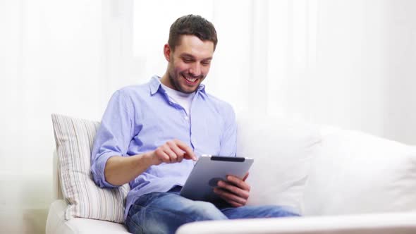 Smiling Man Working With Tablet Pc At Home 8