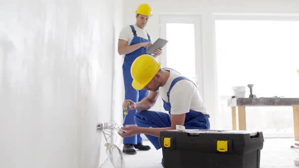 Builders With Tablet Pc And Equipment Indoors 1