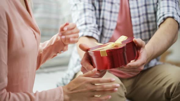 Man Giving Woman Red Gift Box With Perl Jewelry 1