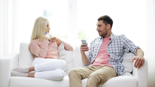 Couple With Smartphones Texting At Home 8